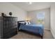 This bedroom features a black dresser, a black leather bed frame, and a window with blinds at 3991 Island Lakes Dr, Winter Haven, FL 33881