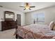 Relaxing bedroom with a four-poster bed, large dresser, and ample natural light from the window at 3991 Island Lakes Dr, Winter Haven, FL 33881