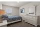The bedroom boasts a white dresser, mirror, and a window with blinds at 3991 Island Lakes Dr, Winter Haven, FL 33881