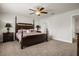 Comfortable primary bedroom showcasing a four-poster bed, ceiling fan, and two nightstands with lamps at 3991 Island Lakes Dr, Winter Haven, FL 33881