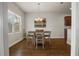 Inviting dining area with hardwood floors and a stylish chandelier above a table with seating for four at 3991 Island Lakes Dr, Winter Haven, FL 33881