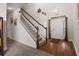Welcoming foyer with hardwood floors, staircase with white railings, and natural light from the front door at 3991 Island Lakes Dr, Winter Haven, FL 33881