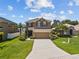 Charming two-story home featuring a well-manicured lawn and an inviting double-car garage at 3991 Island Lakes Dr, Winter Haven, FL 33881