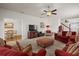 Cozy living room featuring plush carpeting, ceiling fan, and modern television for relaxation at 3991 Island Lakes Dr, Winter Haven, FL 33881