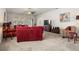 Spacious living room featuring plush carpeting, bright windows, and comfortable furnishings for relaxation at 3991 Island Lakes Dr, Winter Haven, FL 33881