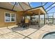 Covered patio perfect for outdoor dining and relaxation features ceiling fan and neutral patio furniture at 3991 Island Lakes Dr, Winter Haven, FL 33881