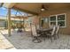 Relaxing covered patio with ceiling fan, ideal for outdoor dining and lounging with neutral stone pavers at 3991 Island Lakes Dr, Winter Haven, FL 33881