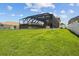 Screened in pool and patio offer seamless indoor-outdoor living within a grassy fenced-in backyard at 3991 Island Lakes Dr, Winter Haven, FL 33881