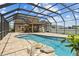 Gorgeous screened-in pool boasts a rock waterfall, water features, and an outdoor dining area at 3991 Island Lakes Dr, Winter Haven, FL 33881