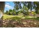 Backyard with lawn, trees, and chain link fence for privacy at 406 Long Dr, Kissimmee, FL 34759