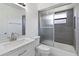 Bathroom featuring a shower with gray tile, white vanity, and silver fixtures at 406 Long Dr, Kissimmee, FL 34759