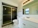 Clean, updated bathroom with a shower, vanity and tile floors at 406 Long Dr, Kissimmee, FL 34759