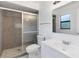 Bright bathroom featuring a vanity, mirror, and shower with stylish tile work at 406 Long Dr, Kissimmee, FL 34759