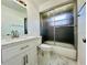 Bright bathroom featuring a white vanity with marble top and a glass-enclosed shower at 406 Long Dr, Kissimmee, FL 34759