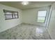 Bright bedroom featuring large windows, modern tile floors and ample space at 406 Long Dr, Kissimmee, FL 34759