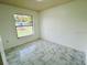 Bright bedroom features large window, tile floors and ample natural light at 406 Long Dr, Kissimmee, FL 34759