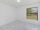 Bedroom features marble-look tile flooring, a window, and plenty of natural light at 406 Long Dr, Kissimmee, FL 34759