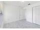 Bedroom boasting marble-look tile floors, a closet, and an open doorway at 406 Long Dr, Kissimmee, FL 34759