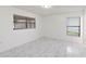 Spacious bedroom with sleek marble-look tile flooring and bright, natural light at 406 Long Dr, Kissimmee, FL 34759