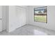 Bedroom includes marble-look tile floors, a window, and a closet at 406 Long Dr, Kissimmee, FL 34759