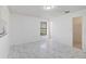 Inviting bedroom featuring marble-look tile, a window, and an open closet at 406 Long Dr, Kissimmee, FL 34759