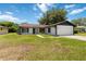 Single-Gathering home with black and white accent and an attached two-car garage at 406 Long Dr, Kissimmee, FL 34759