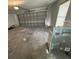 Spacious garage featuring a large door, concrete floors, and natural lighting from a window at 406 Long Dr, Kissimmee, FL 34759