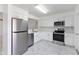 Modern kitchen features stainless steel appliances and white cabinets at 406 Long Dr, Kissimmee, FL 34759