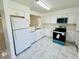 Well-lit kitchen with bright white cabinets, tile floors and updated appliances at 406 Long Dr, Kissimmee, FL 34759