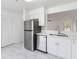 Modern kitchen features stainless steel appliances and white cabinets at 406 Long Dr, Kissimmee, FL 34759