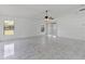Spacious living room features marble-look tile floors and a ceiling fan at 406 Long Dr, Kissimmee, FL 34759