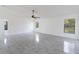 Bright, open-concept living room features marble-look floors and ample natural light at 406 Long Dr, Kissimmee, FL 34759