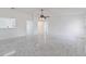 Bright, open-concept living room features marble-look floors and ample natural light at 406 Long Dr, Kissimmee, FL 34759