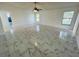 Spacious living room with tiled floors, fan and lots of natural light at 406 Long Dr, Kissimmee, FL 34759
