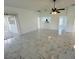 Open-concept living room featuring modern tile flooring and seamless transition to a breakfast bar and kitchen at 406 Long Dr, Kissimmee, FL 34759