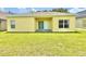The back of the home features a patio area and a spacious backyard with a lush green lawn at 4307 Creeks Run Blvd, Kissimmee, FL 34746