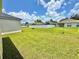 Expansive backyard showcases the lush green grass, white vinyl fence, and neighboring homes at 4307 Creeks Run Blvd, Kissimmee, FL 34746