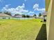Sprawling backyard featuring lush green grass, white vinyl fence and neighboring houses at 4307 Creeks Run Blvd, Kissimmee, FL 34746