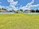Large backyard enclosed by a white vinyl fence and lush green grass at 4307 Creeks Run Blvd, Kissimmee, FL 34746