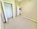 Neutral bedroom features beige carpeting, closet, and doorway leading to the rest of the home at 4307 Creeks Run Blvd, Kissimmee, FL 34746