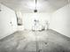 Bright, spacious garage with concrete floors, refrigerator, water heater, and garage door at 4307 Creeks Run Blvd, Kissimmee, FL 34746