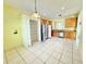 Bright kitchen featuring wooden cabinetry, stainless steel appliances, tile flooring and walk-in pantry at 4307 Creeks Run Blvd, Kissimmee, FL 34746