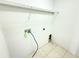Functional laundry room with tiled floor, shelving, and washer hookups at 4307 Creeks Run Blvd, Kissimmee, FL 34746