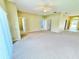 A spacious living room features neutral carpeting, bright walls and multiple entry points at 4307 Creeks Run Blvd, Kissimmee, FL 34746