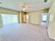 Spacious living room with sliding glass doors and neutral carpet at 4307 Creeks Run Blvd, Kissimmee, FL 34746