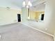 A spacious living room features neutral carpeting, bright walls and a breakfast bar into the kitchen at 4307 Creeks Run Blvd, Kissimmee, FL 34746