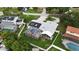 A beautiful aerial view of a home showcasing its pool, lanai, solar panels, and well-maintained yard at 4407 Lake Trudy Dr, St Cloud, FL 34769
