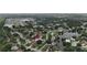 Expansive aerial view of a residential area, highlighting homes near a tranquil lake and lush greenery at 4407 Lake Trudy Dr, St Cloud, FL 34769