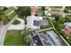 A picturesque aerial view of a home shows the pool, a lanai, solar panels, and the driveway at 4407 Lake Trudy Dr, St Cloud, FL 34769