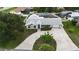 Spacious property with a circular driveway, solar panels, and a screened pool enclosure at 4407 Lake Trudy Dr, St Cloud, FL 34769